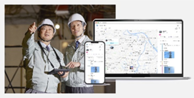 ヘルメットを着用し作業着を着た2人の男性、スマートフォンとタブレットの写真