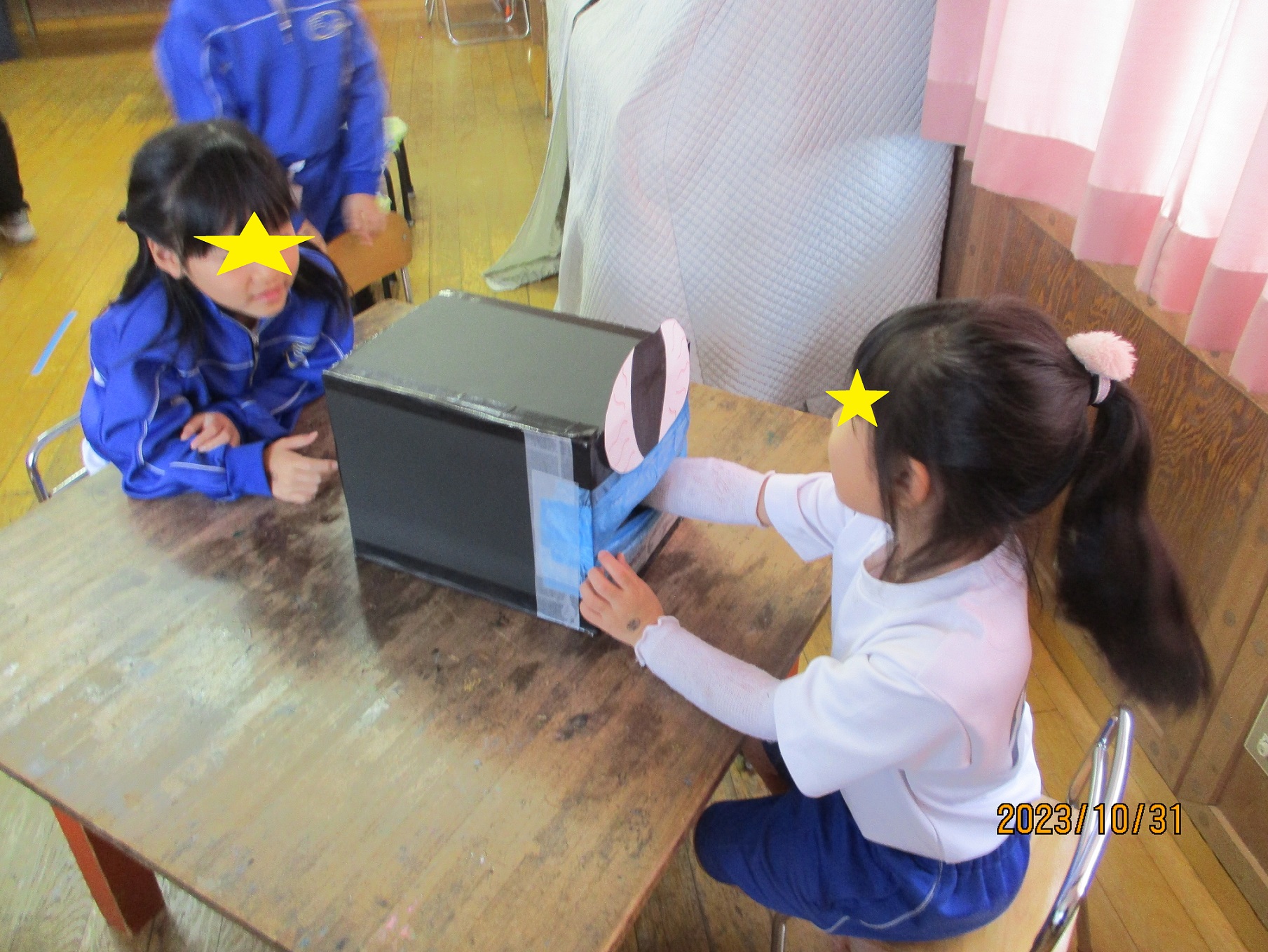 ハロウィンの箱の中身当てゲームに参加する子供たち