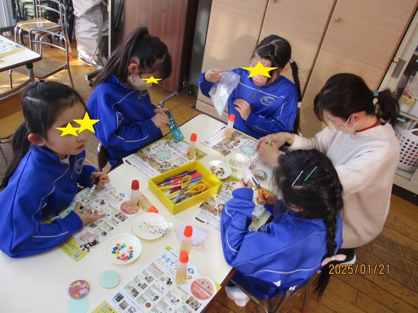 缶バッチの下絵をデコレーションする子供たち