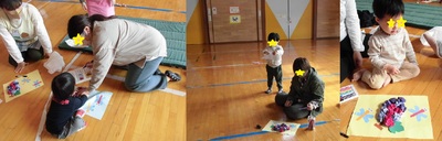 画用紙に折り紙を貼り付けて工作している親子の写真