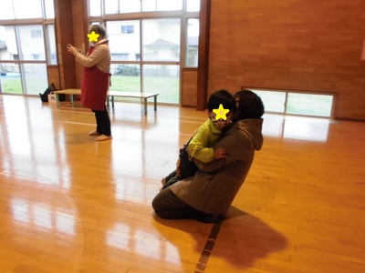 かけっこで走ってきた子どもを抱きしめるお母さんの写真