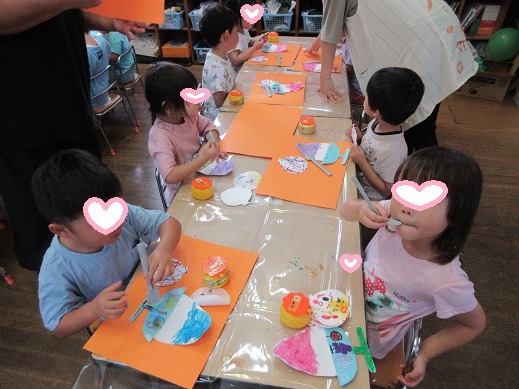 かき氷やスプーンの制作を糊付けする4歳児
