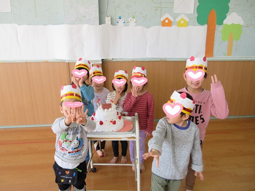 ケーキを前に、みんなにお祝いされて嬉しそう