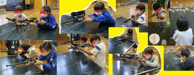 狙いを定めて的に銃口を向けている子どもたちの写真