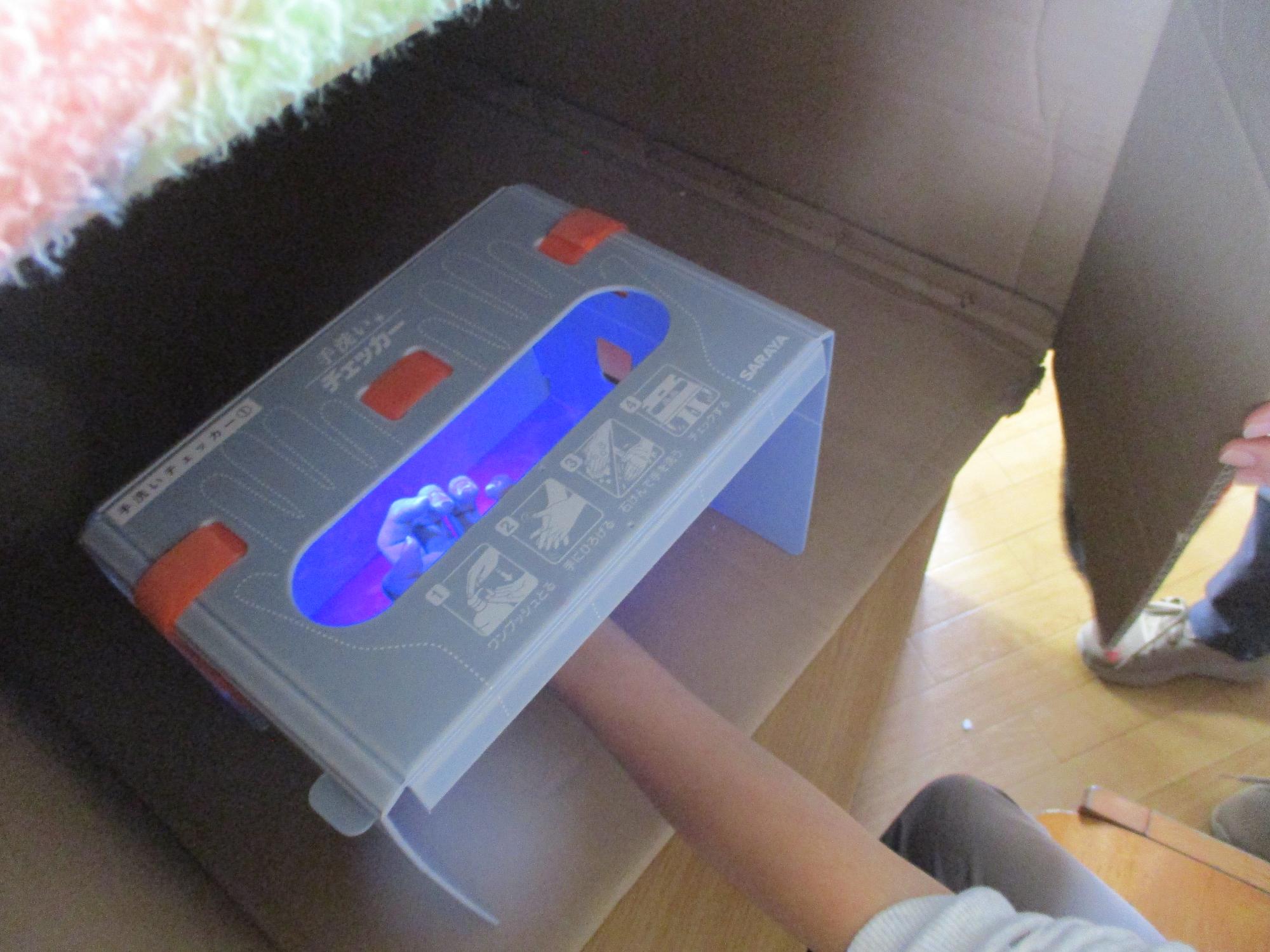 手洗いチェッカーに手を入れている子