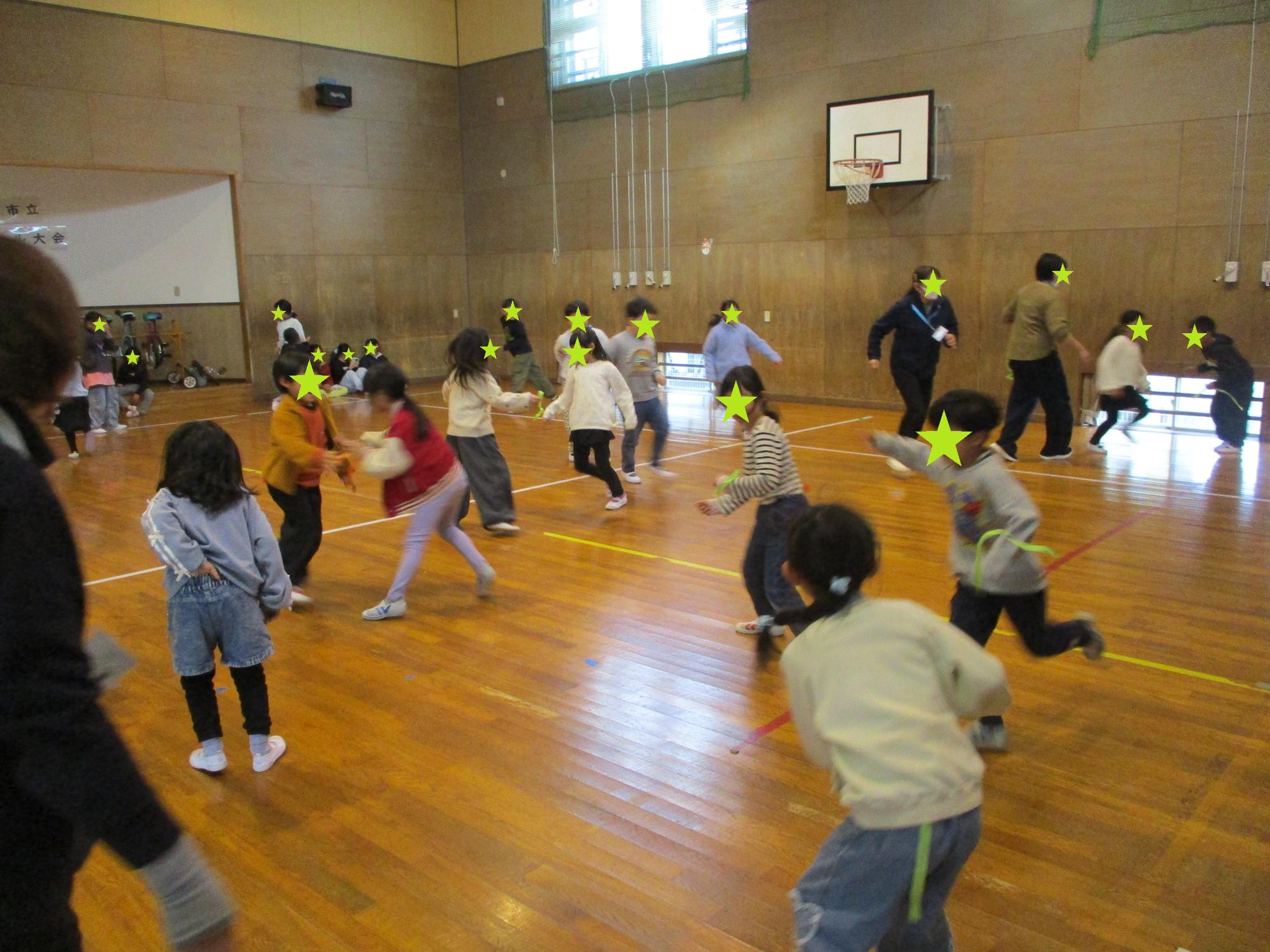 しっぽとりで遊ぶ子どもたちと先生
