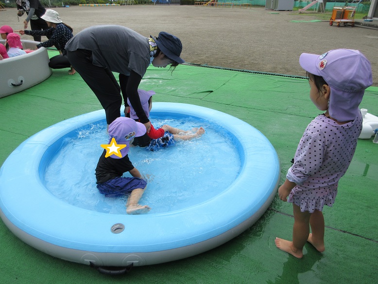 水たまりプールで先生に身体をゆらゆらさせてもらいます。