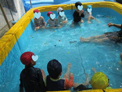 プールの中で向かい合って座り、間にはたくさんのスーパーボール