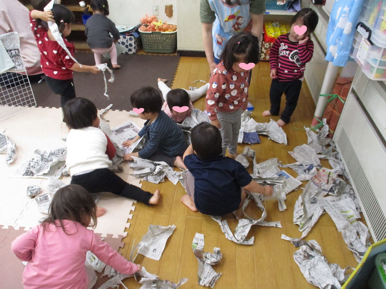 新聞紙をちぎって遊んでいる